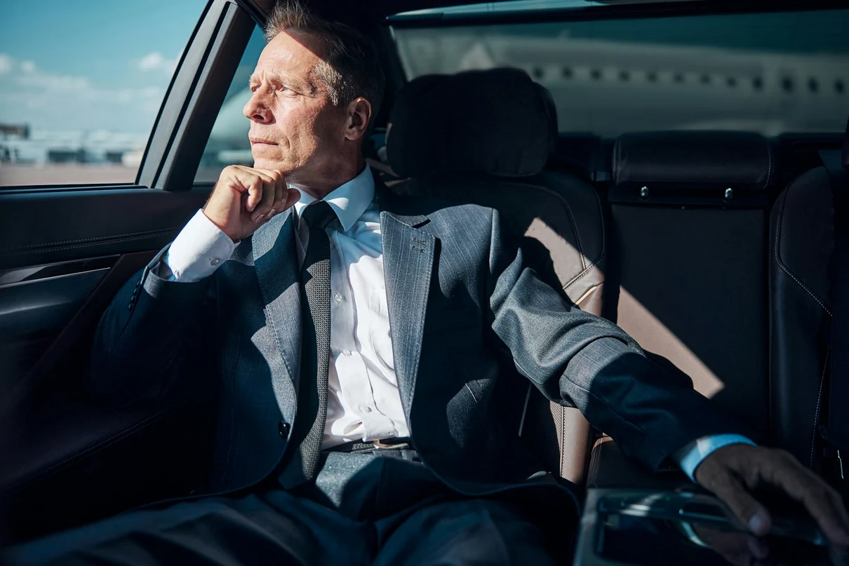 Affluent Dilemma: A person in a luxurious car contemplating choices
